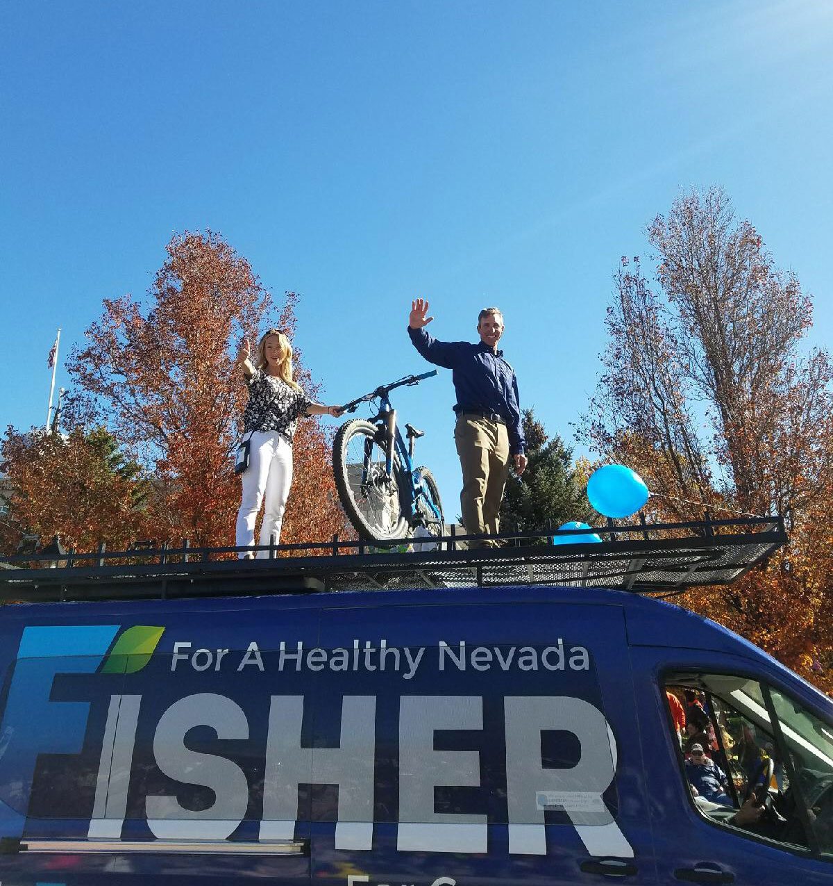 Jared and Heather waving from the Fisher for Nevada